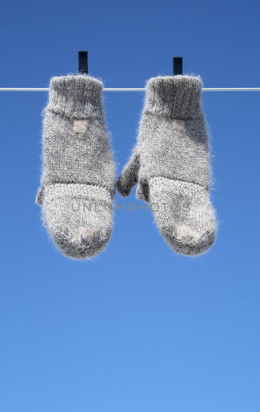 Mittens on the clothes-line hanging to dry � the winter is over