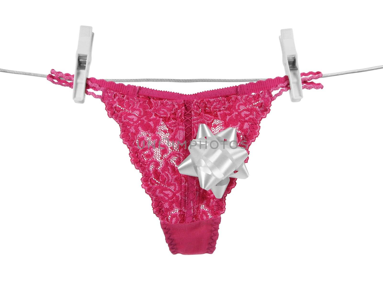 Pink lacy panties with a gift bow, hanging on a clothes-line. Contains 3 clipping paths: bow, clothes-line with pegs and all the image (panties, bow and clothes-line with pegs).