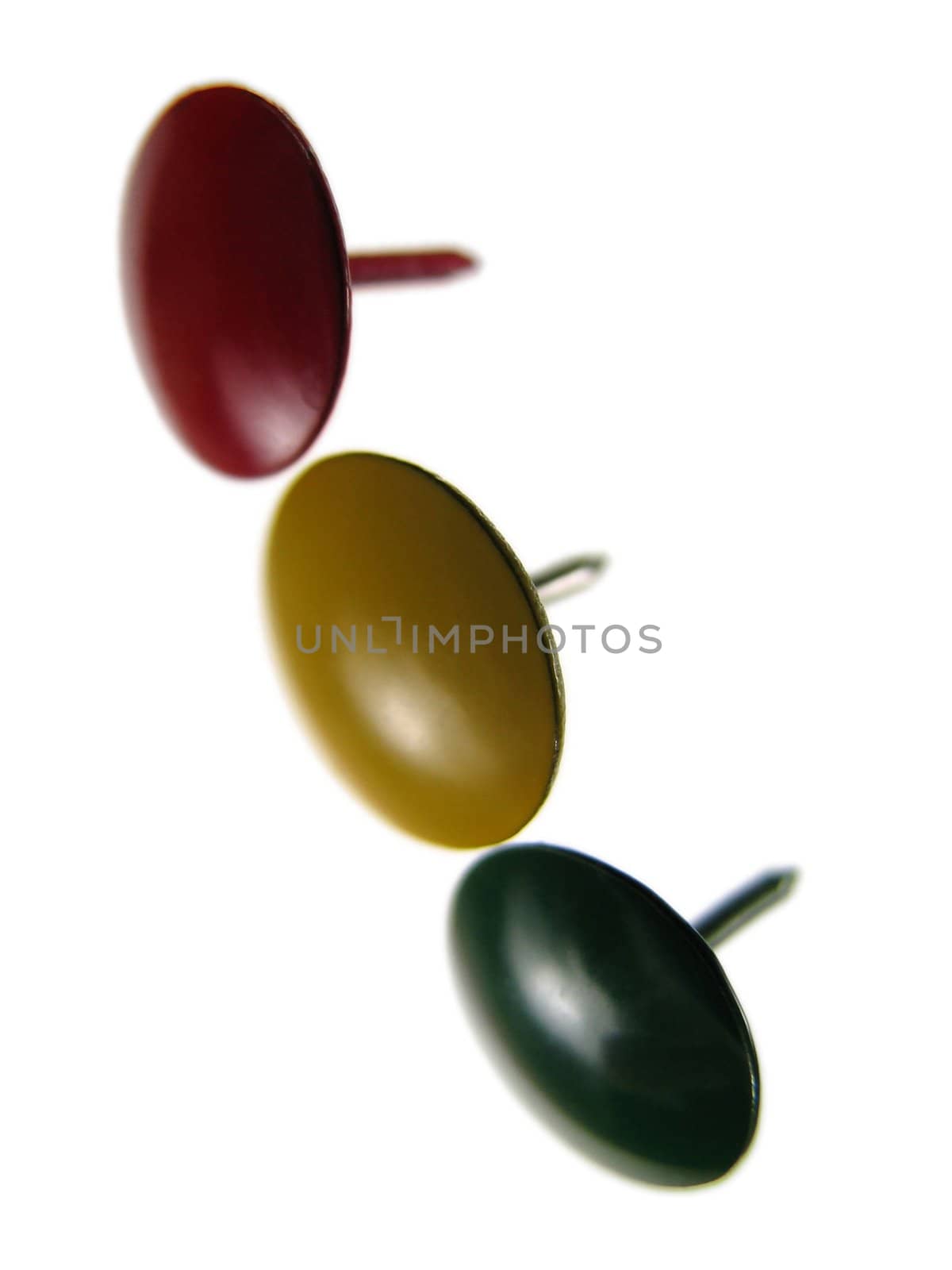 Three sharp thumbtacks representing traffic lights, on white background.