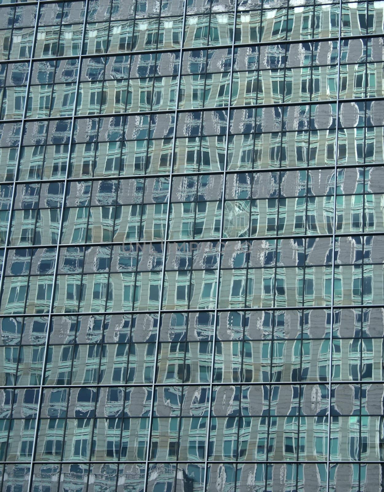 Abstract green reflections in the windows of a skyscraper.