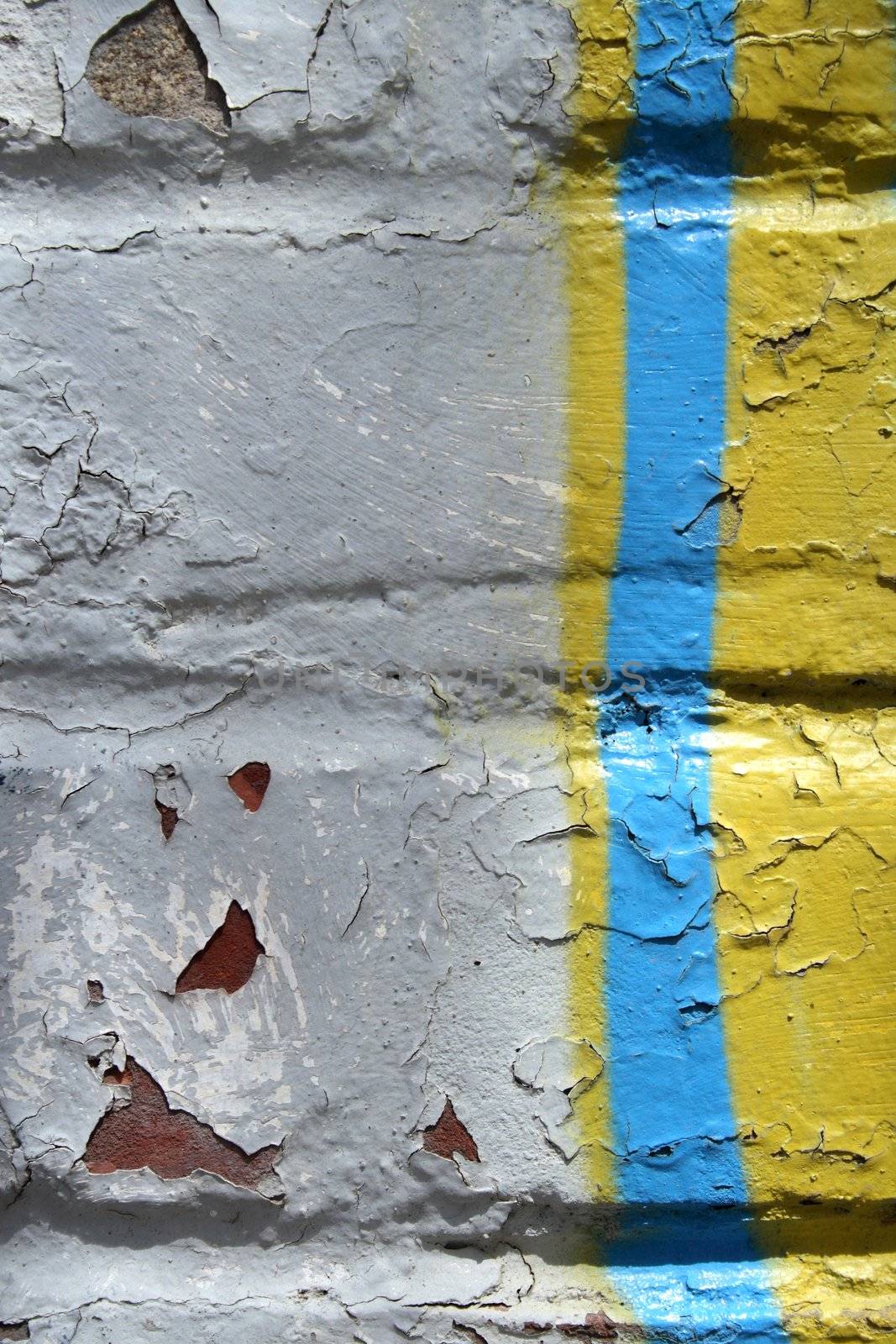 Detail of colorful graffiti on a peeling painted wall.