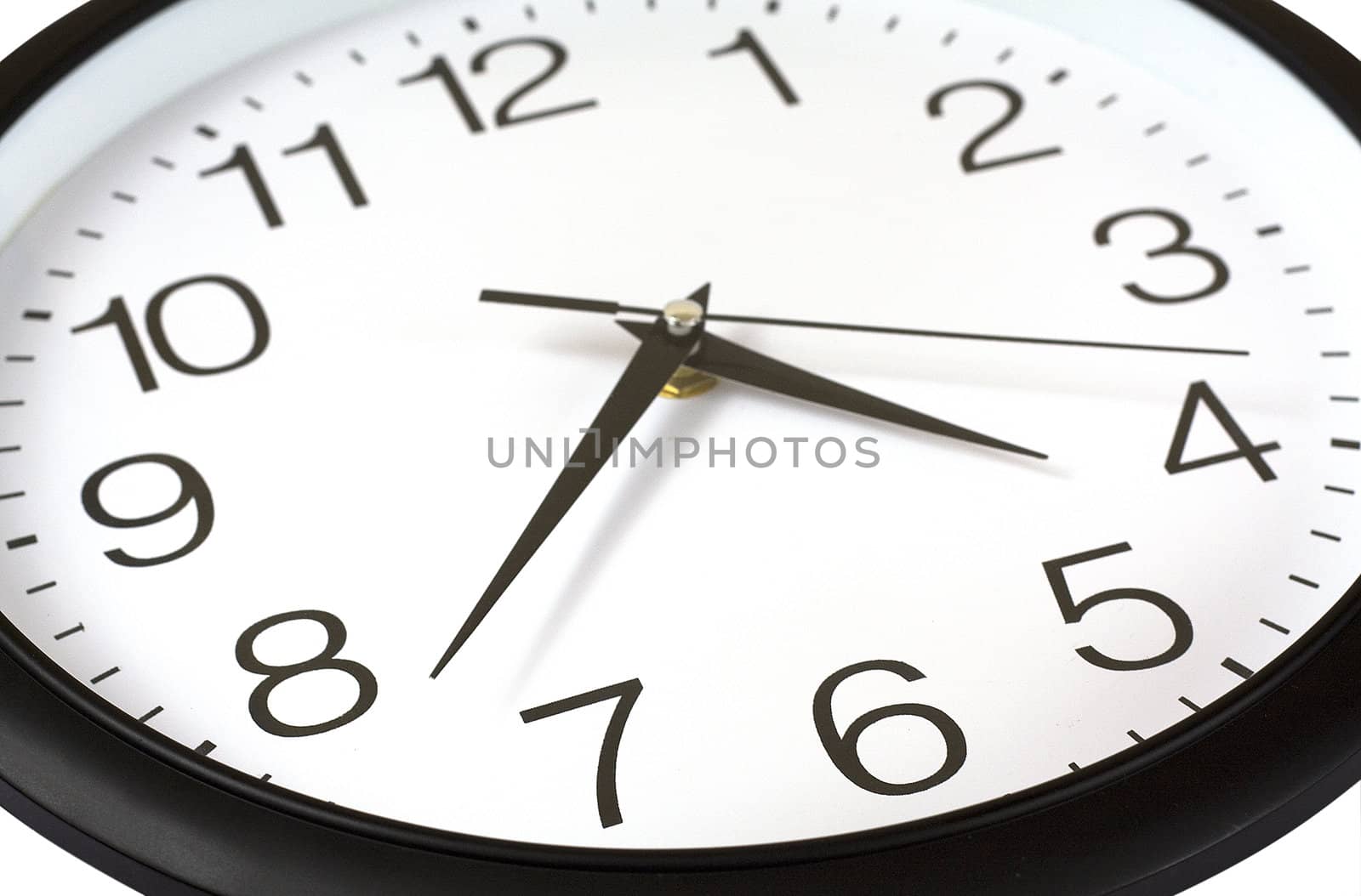 Closeup of black and white wall clock with three hands isolated over white.