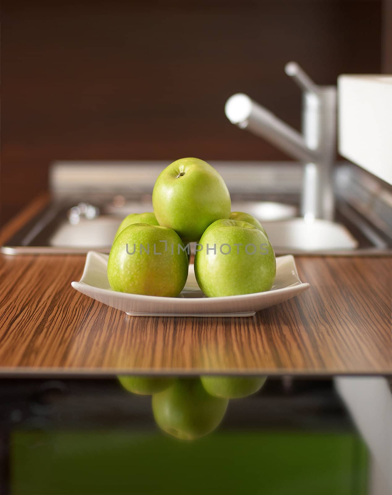 Green apples on table by DmitryYakunin