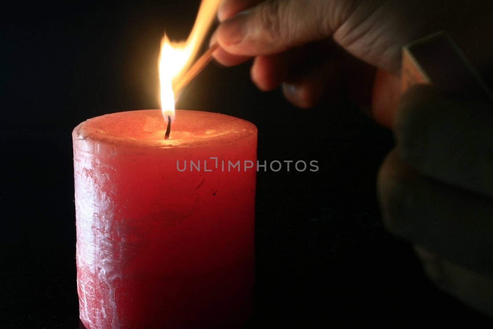 To light a candle concept in a black background