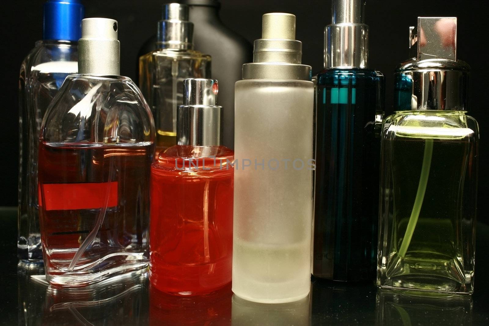 fragrances and perfume bottles on a black background
