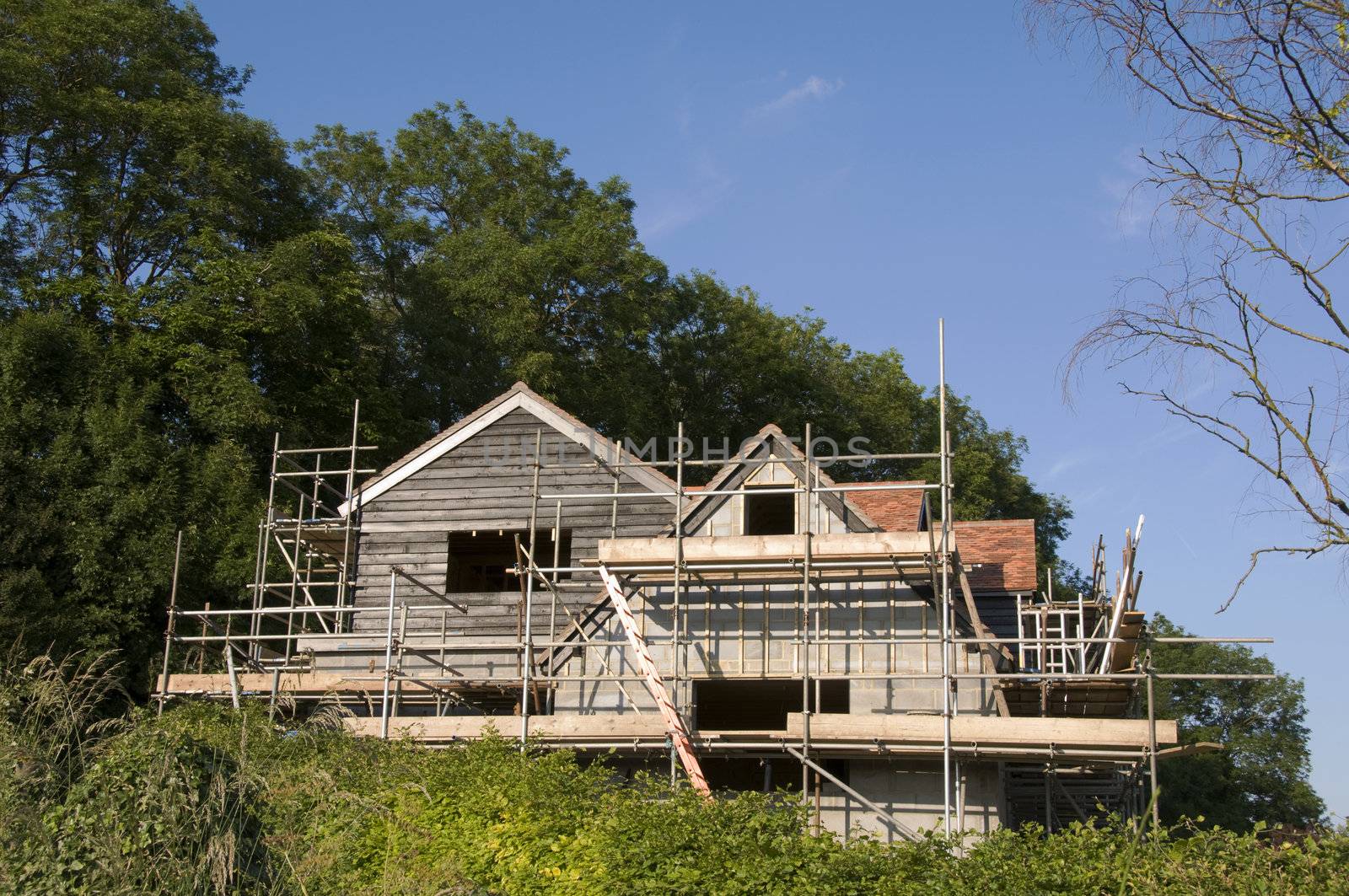 Scaffolding around  the back of a new house in the countryside