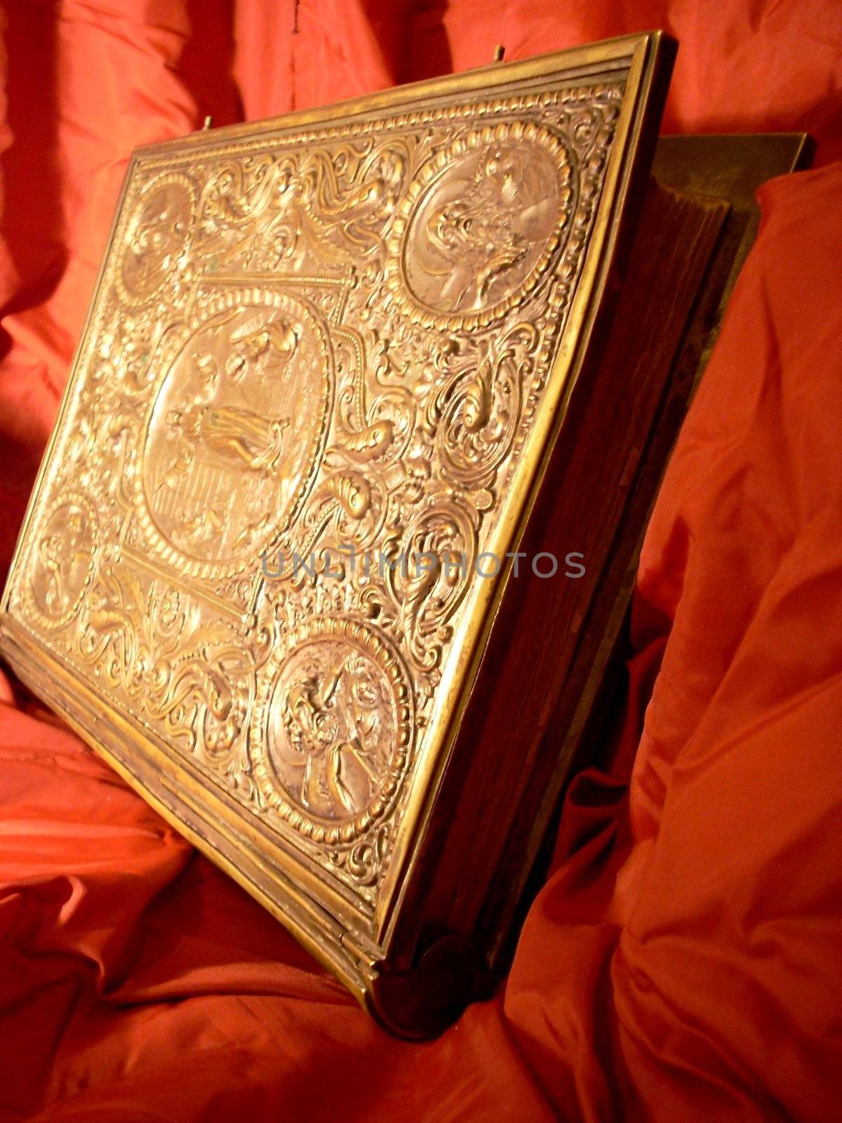 very old Bible on a Red shining silk background