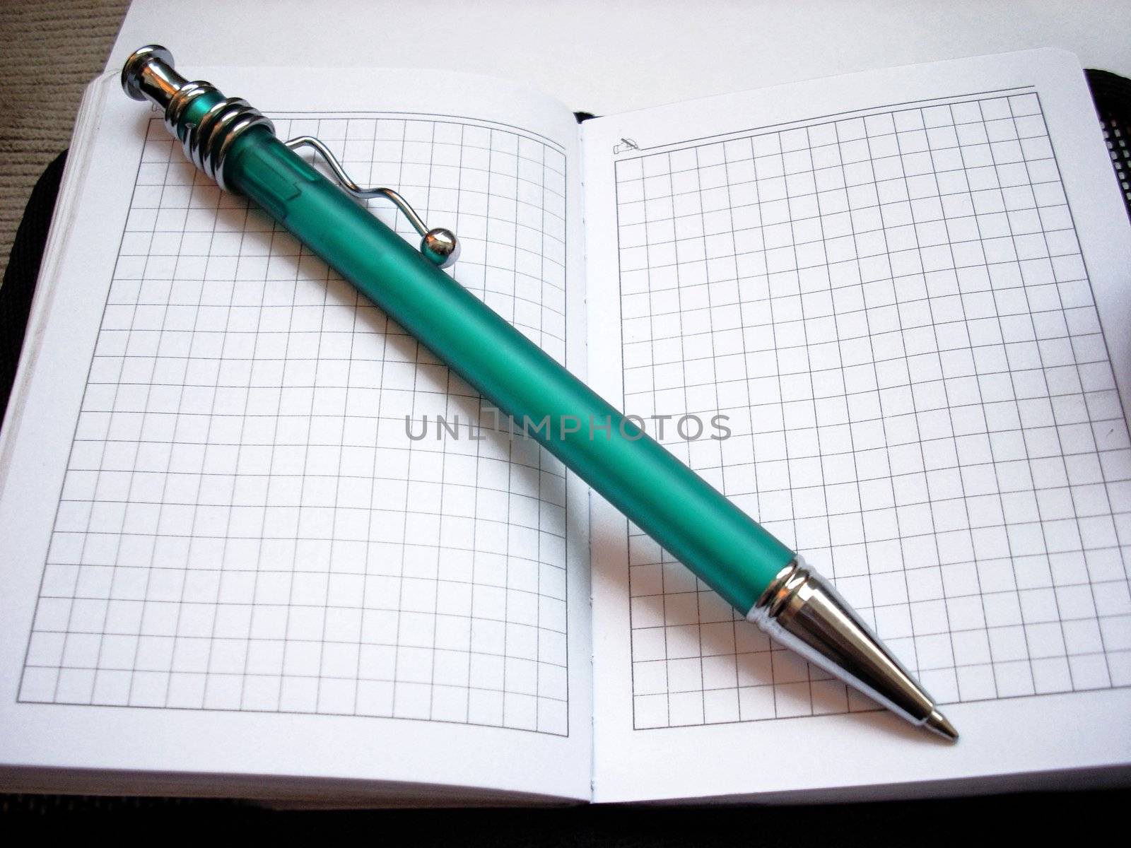 A photograph of ballpoint and writing-pad