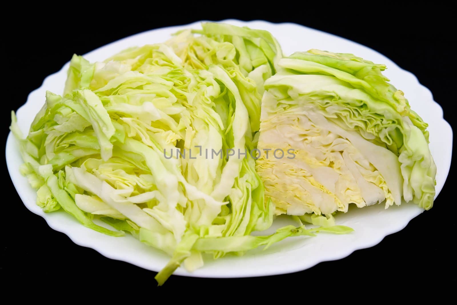 cut fresh cabbage on a white plate