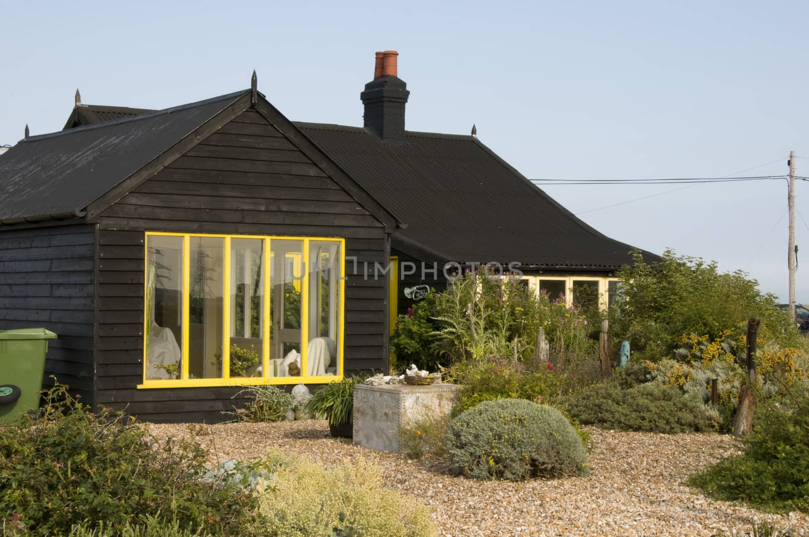 A wooden house with a shingle garden