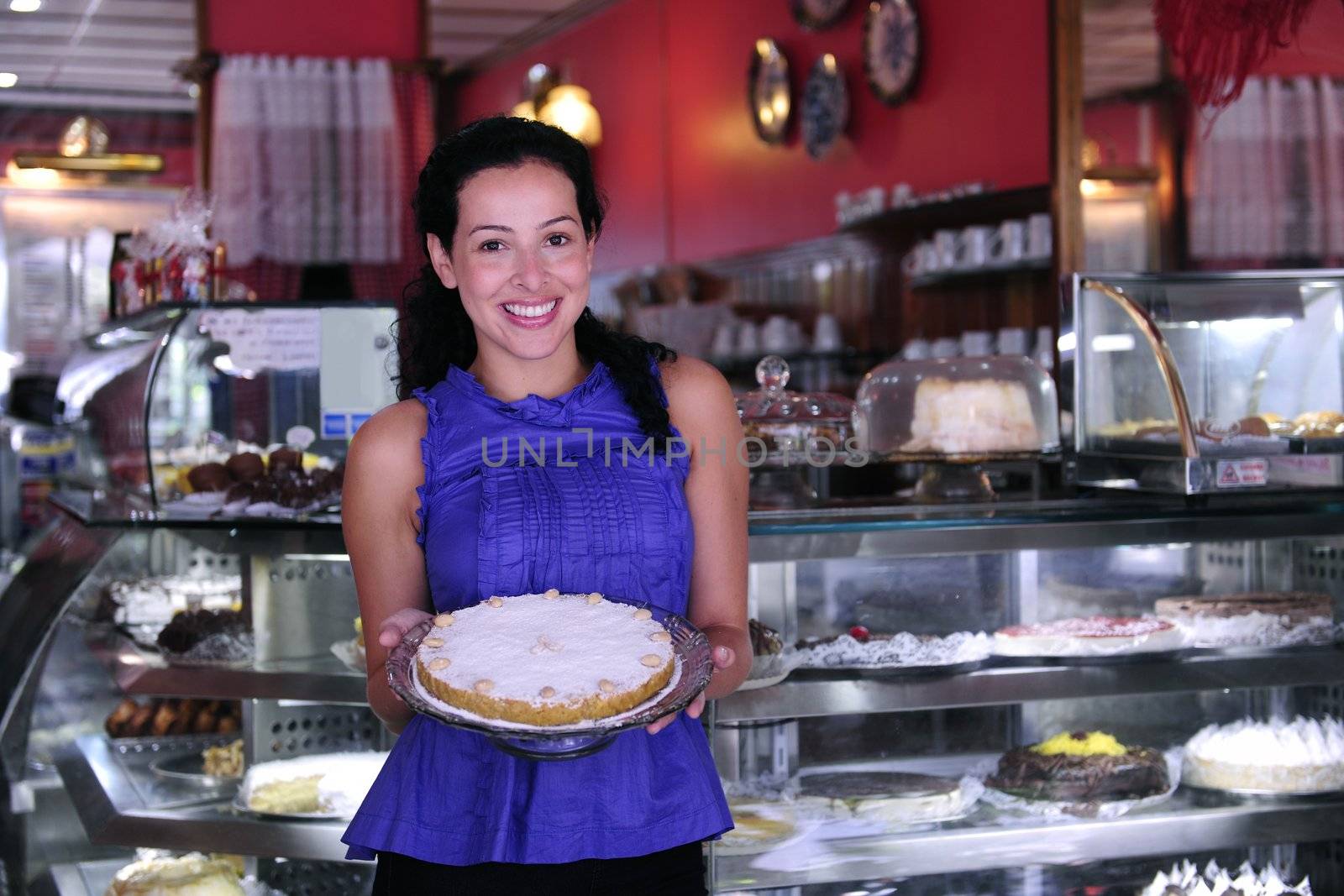 owner of a small business store showing her tasty cakes