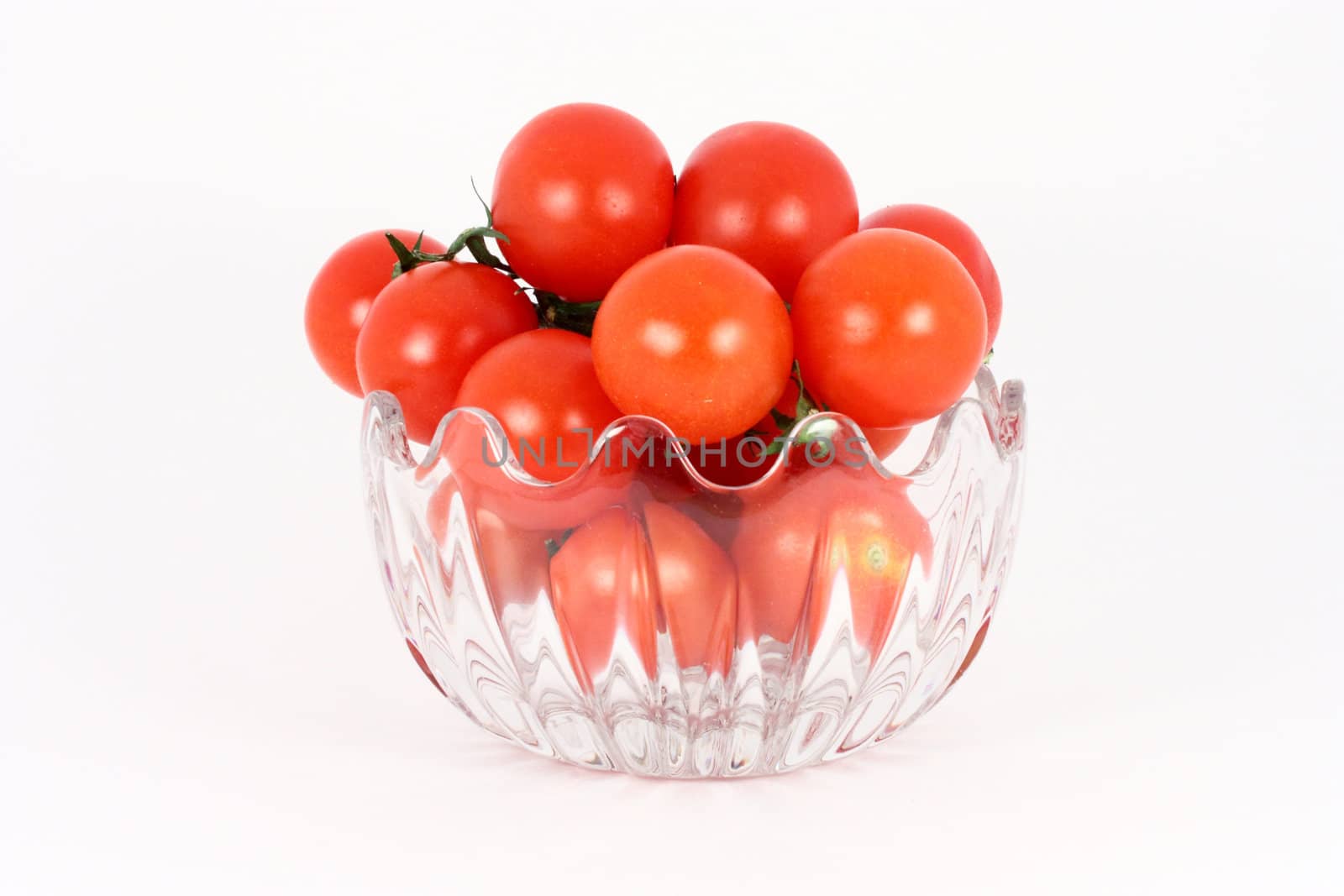 Cherry tomato in glass bowl isolated on white