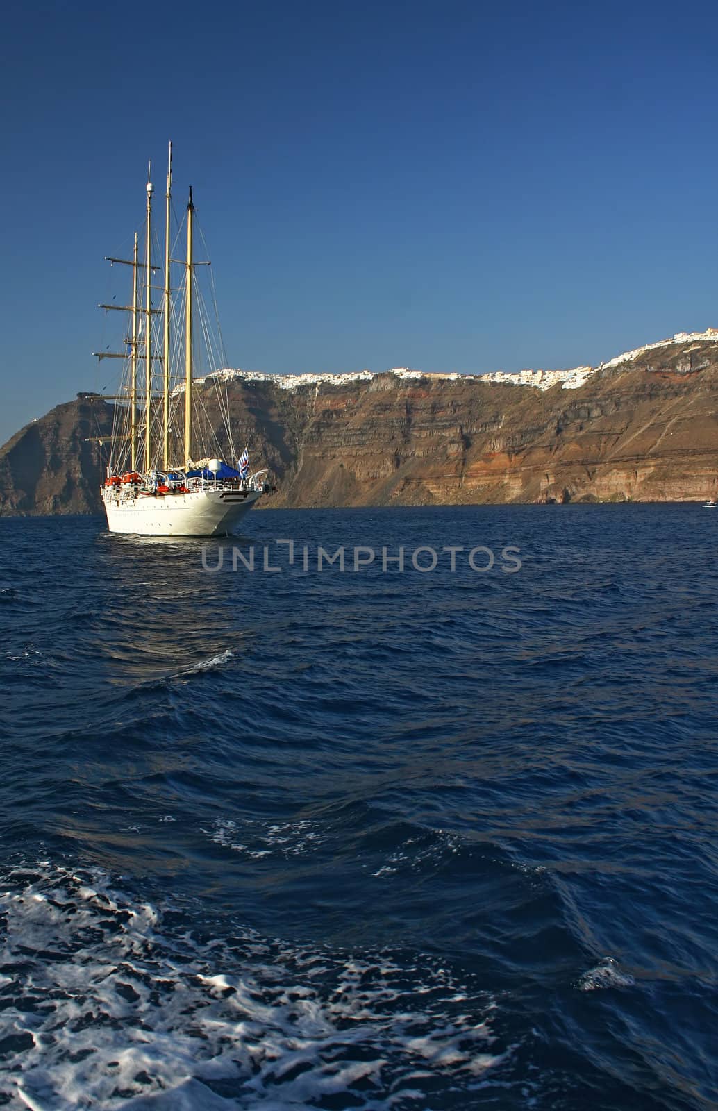 ship on the sea near Oia town on Santorini island in Greece