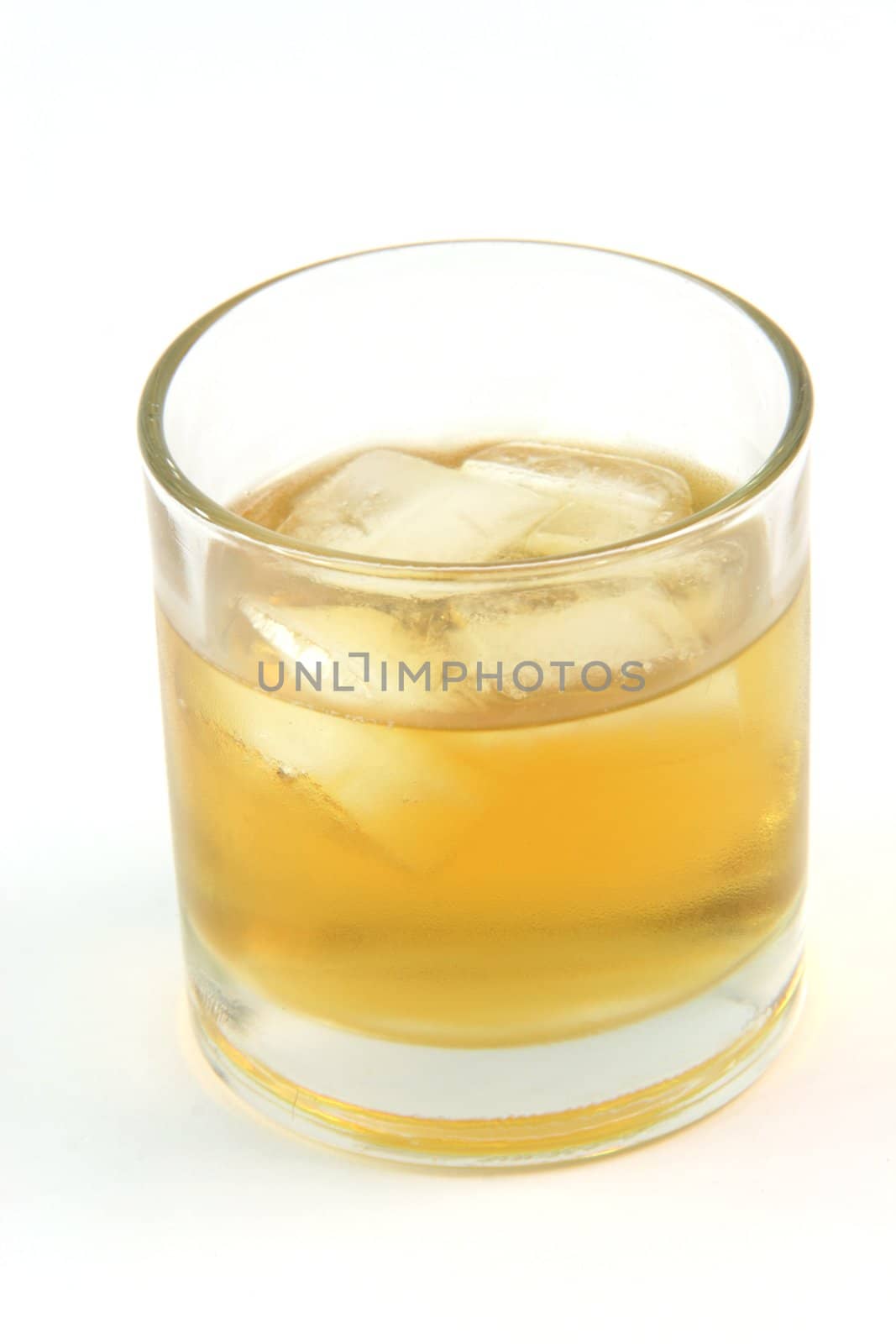 glass with whiskey on the rocks isolated on white background