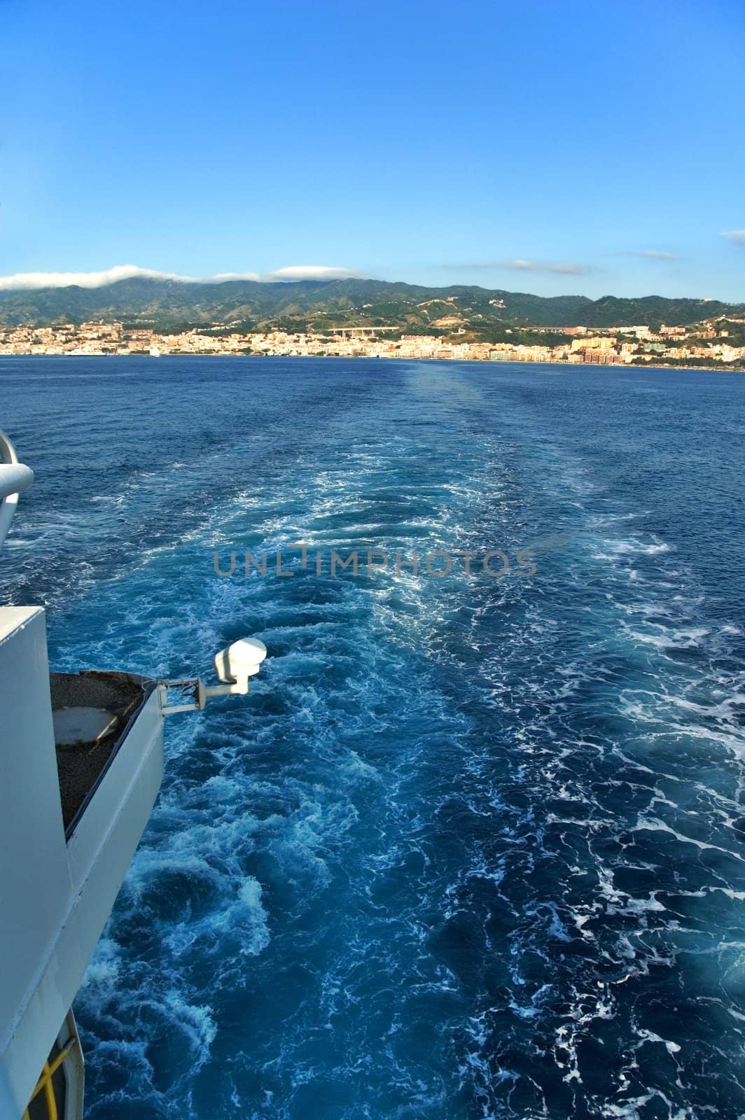 View from a ship with sea waves and distant land