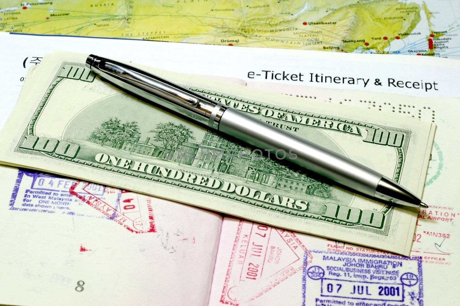 Travel Documents e-ticket itenerary with dollar and pen