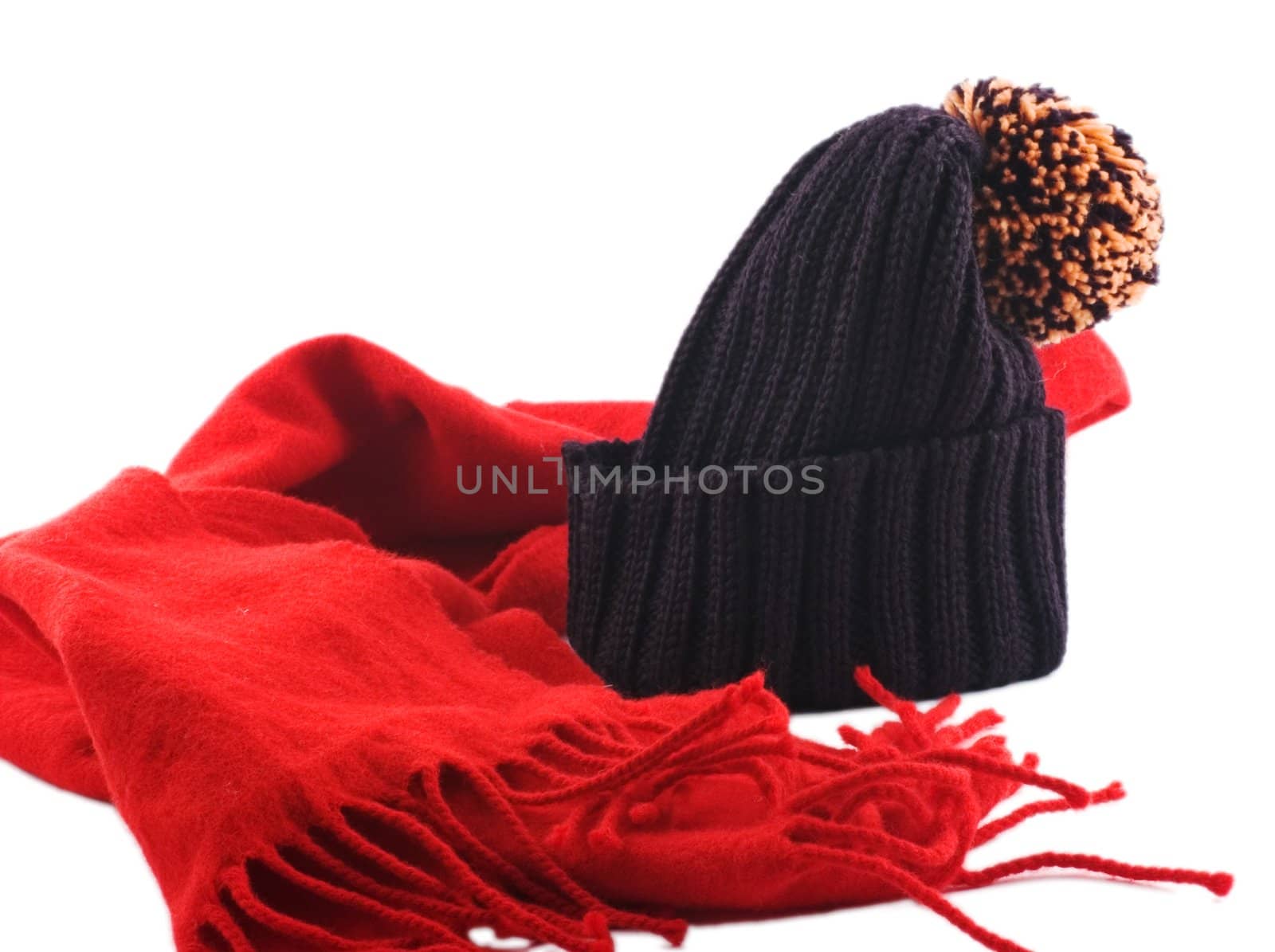 Red scarf and woolen ski cap isolated on white