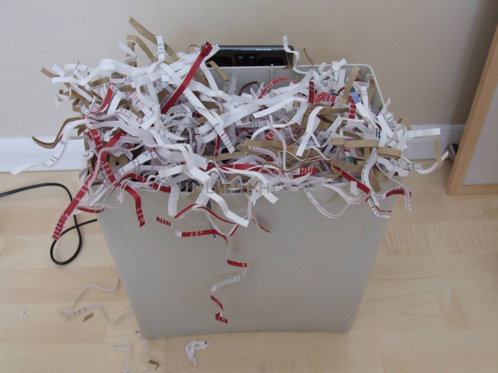 shredded paper overflowing from a bin