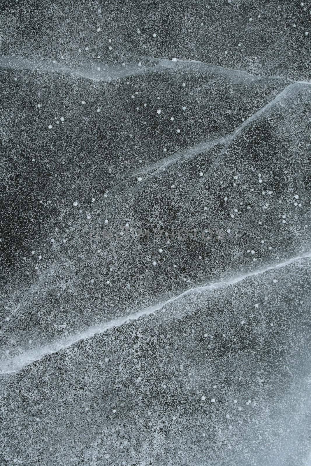 Grainy snow covering cracked ice by anikasalsera