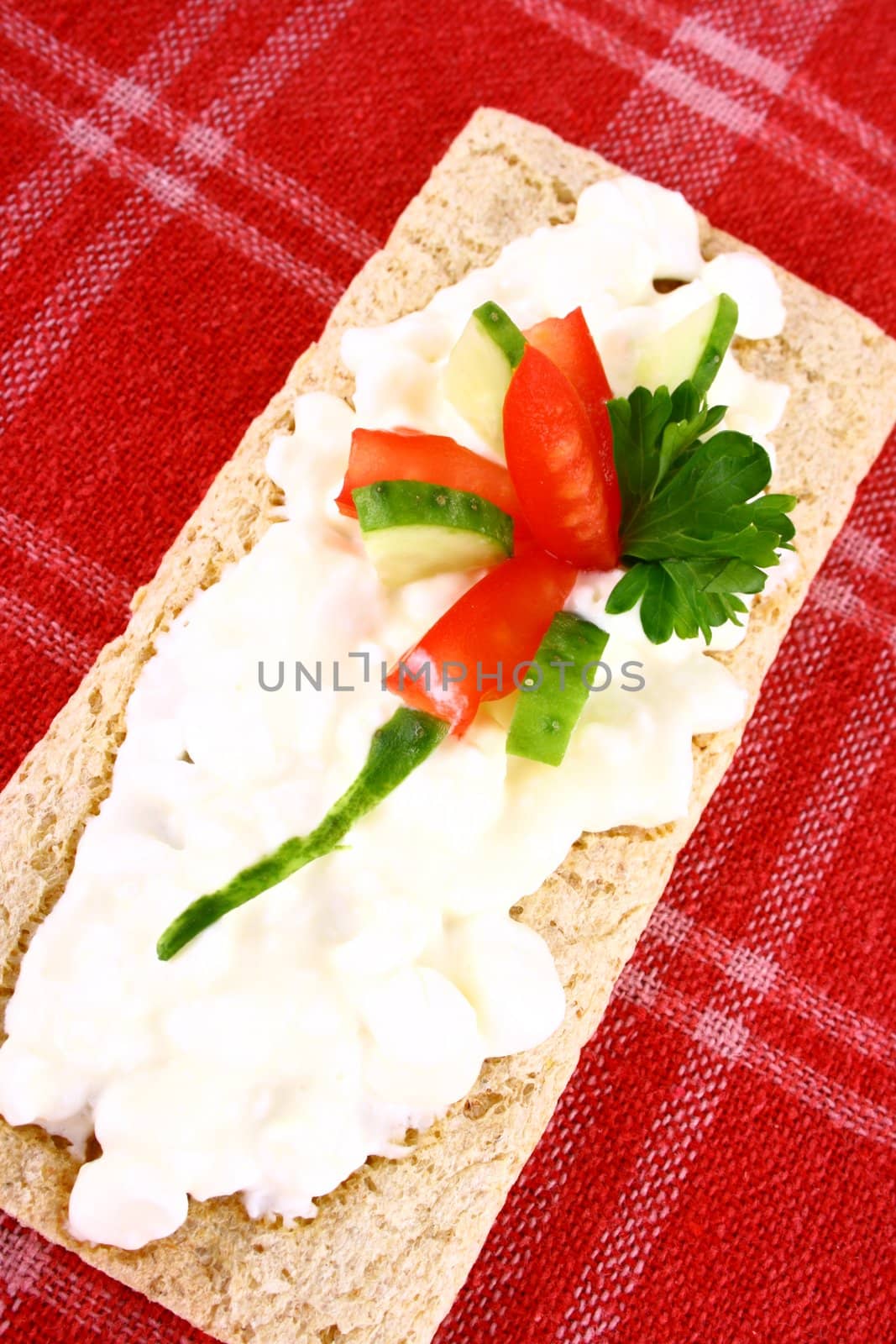 A healthy sandwich with tomato green and red vegetables