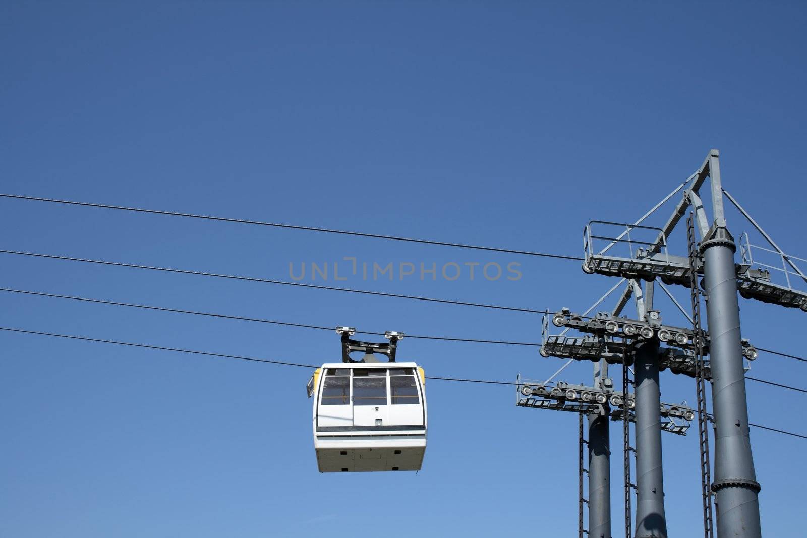 White cable car going up to the mountain.