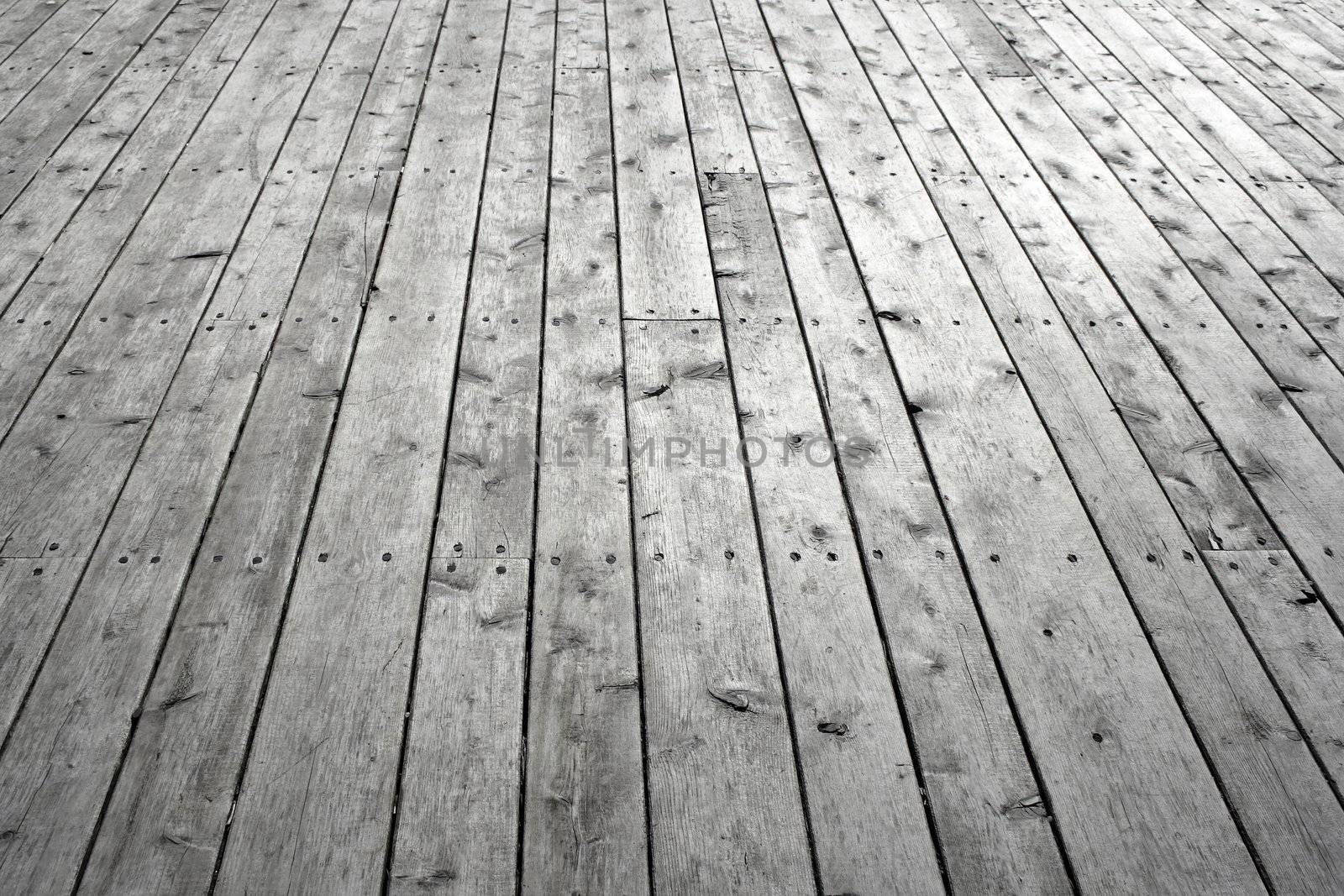 Unpainted wooden floor. Gray knotty wooden planks.