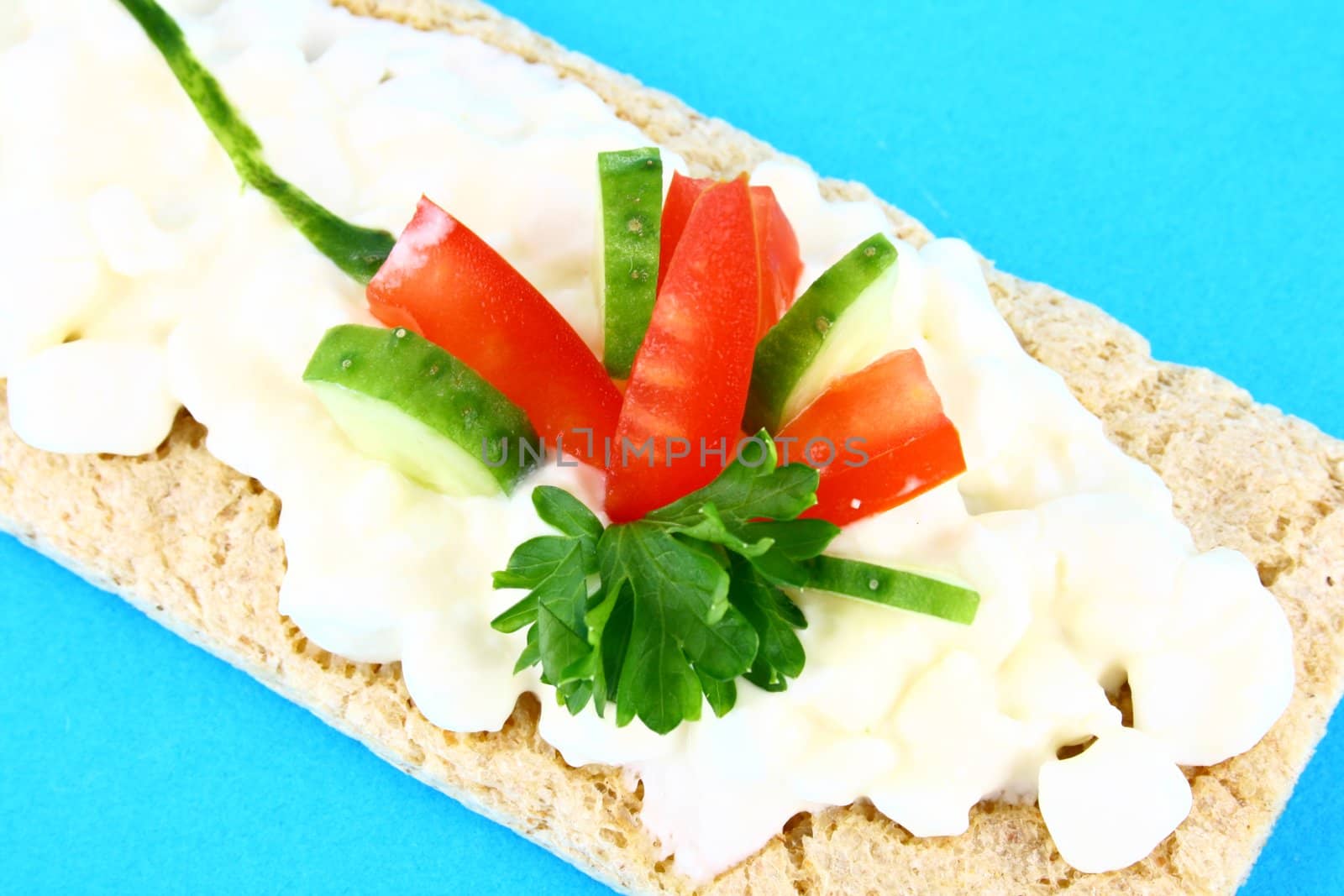 A healthy sandwich with tomato green and red vegetables