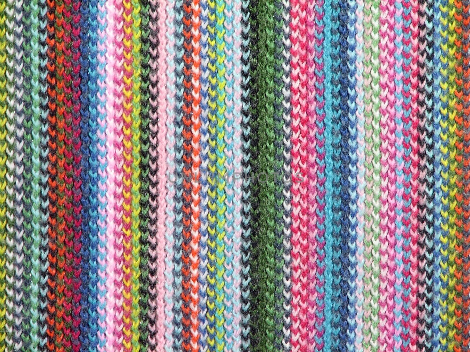 Colorful textile background. Closeup of a vivid knitted scarf.