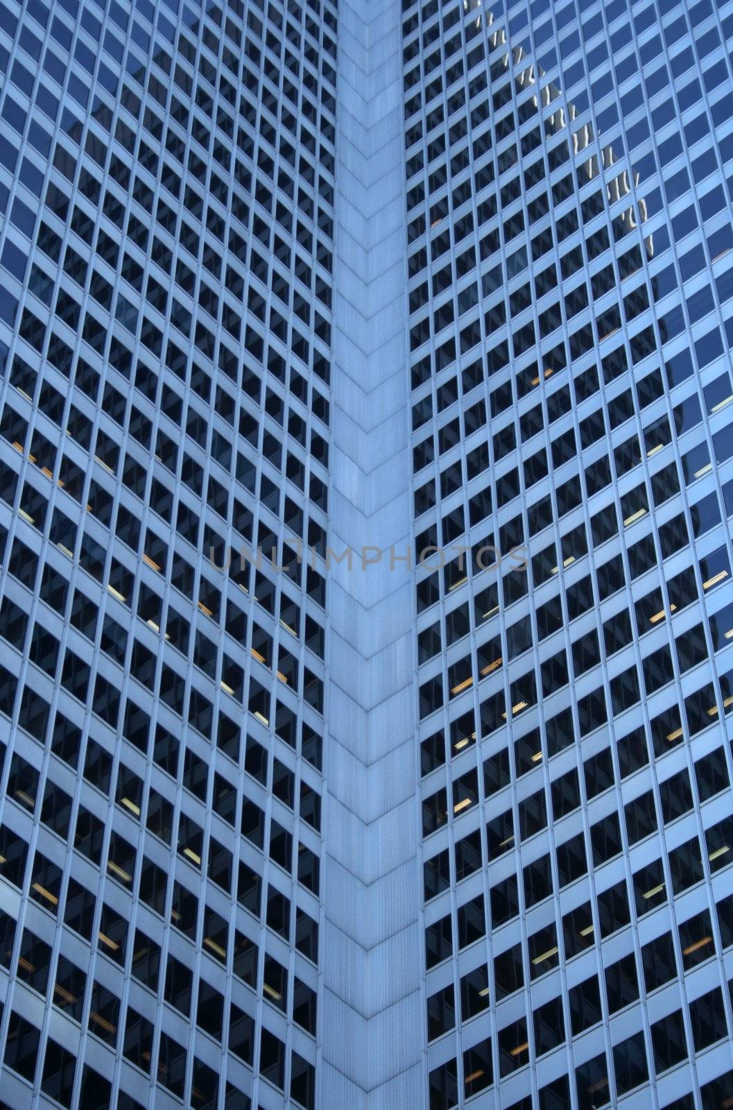 Inside corner of a glass-windowed office tower by anikasalsera