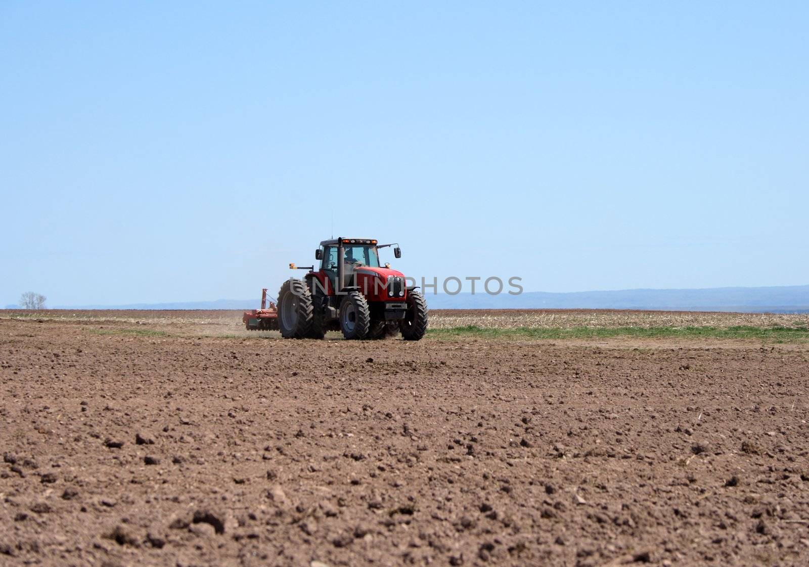 Tractor plowing land by anikasalsera