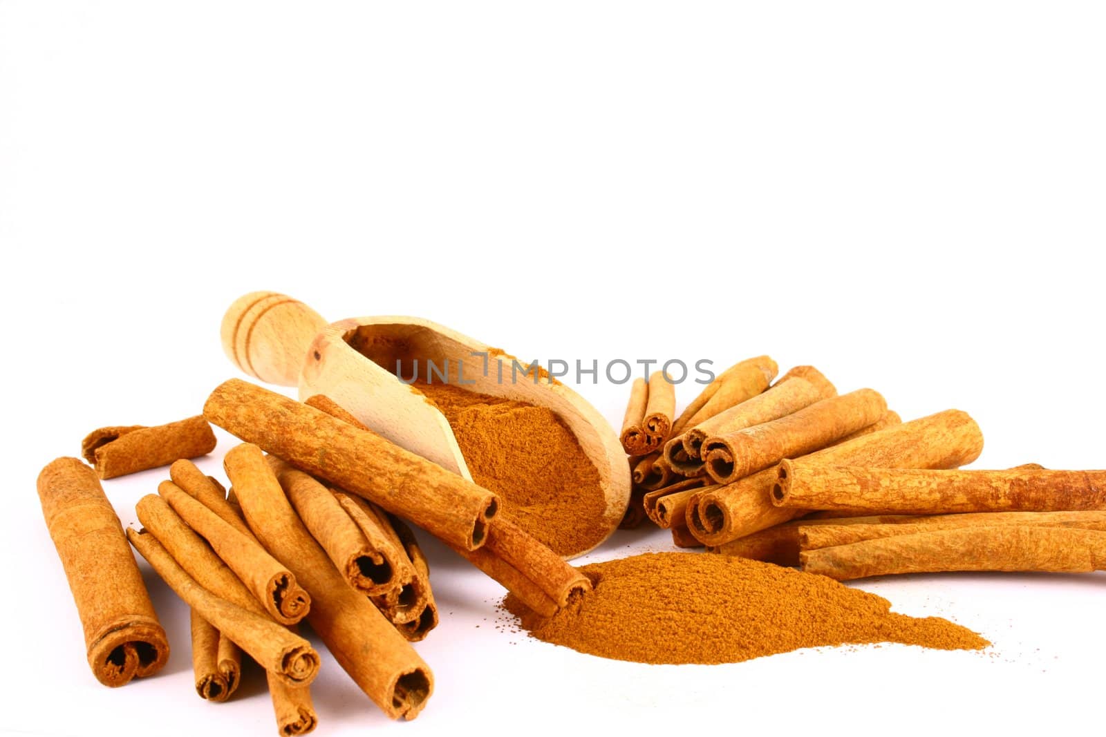 Sticks and powder of cinnamon reflected on the white background