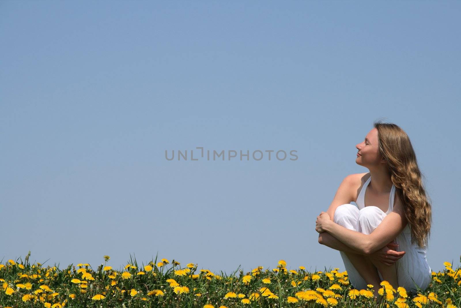 Young woman enjoying sunshine by anikasalsera
