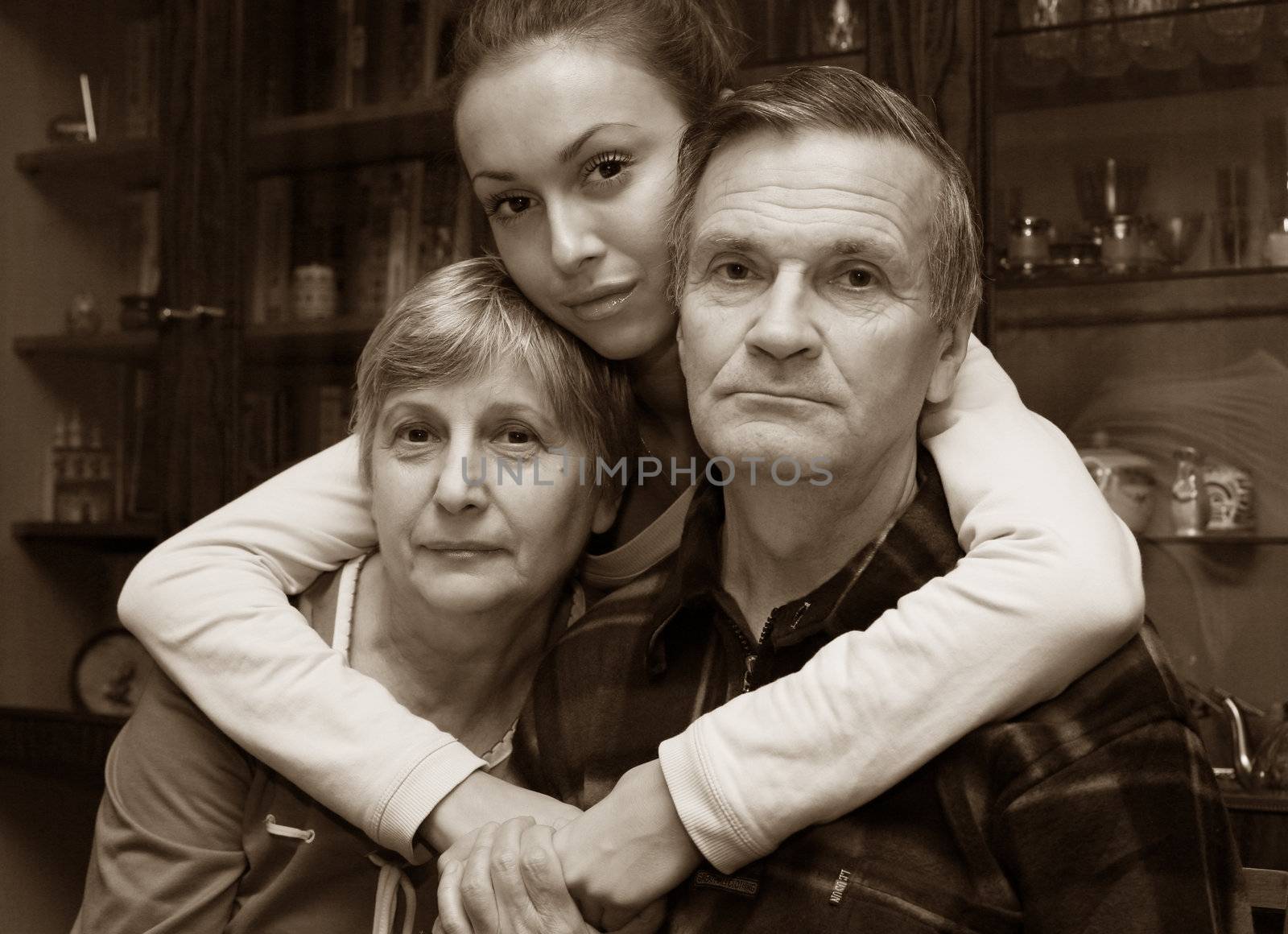 The grand daughter embraces the grandmother and the grandfather