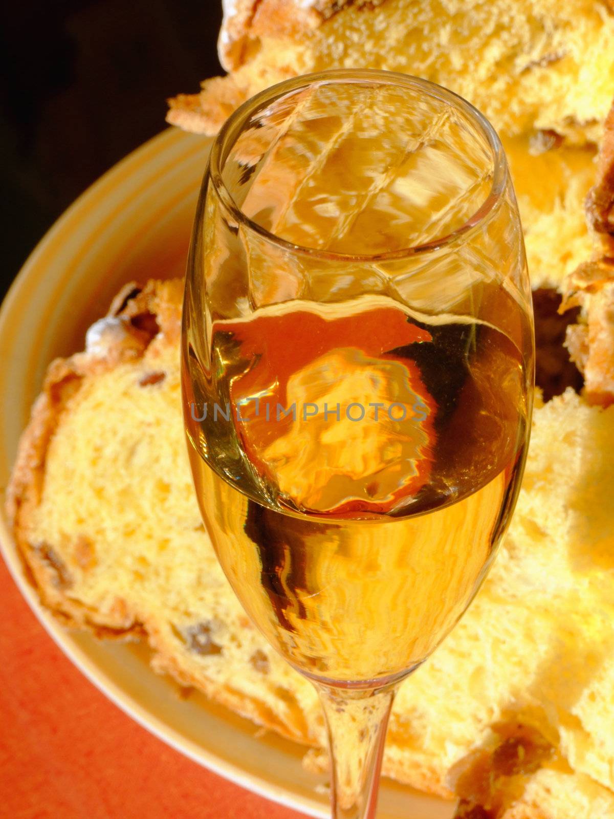 An italian Christmas table with glass of spumante and panettone