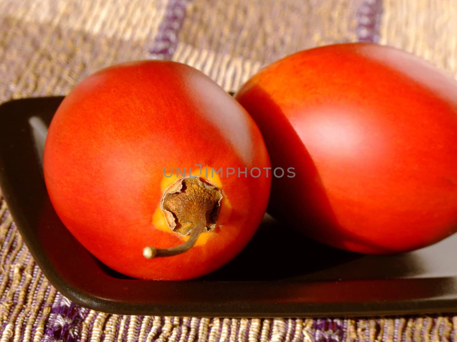 Close-up of two ripe tamarillos