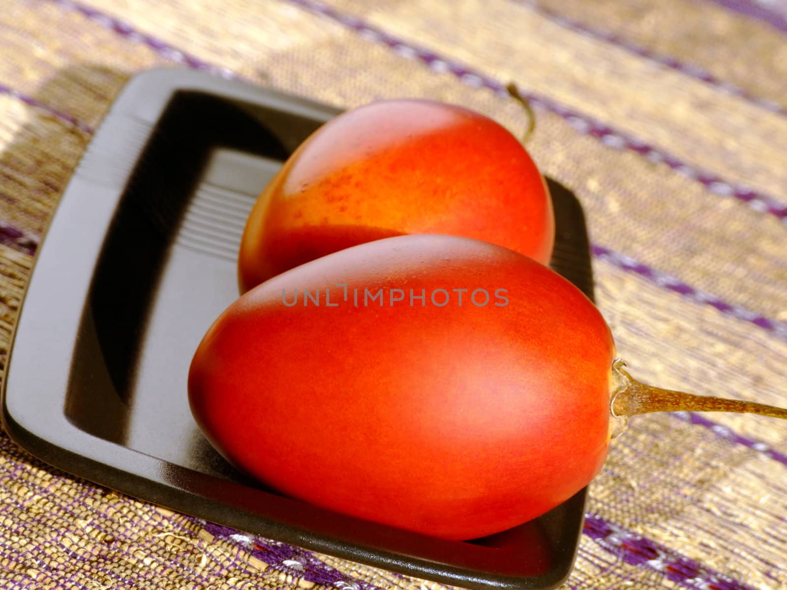 Close-up of two ripe tamarillos