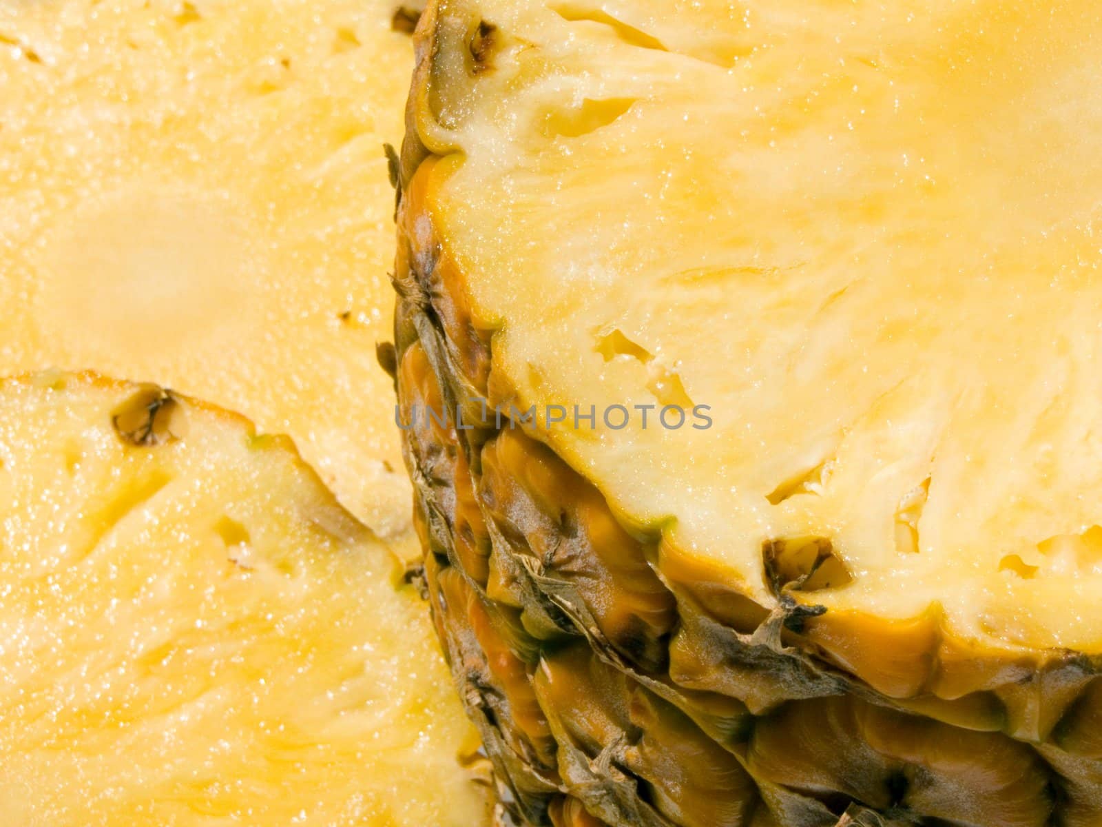 Close-up of half and two slice of pineapple 