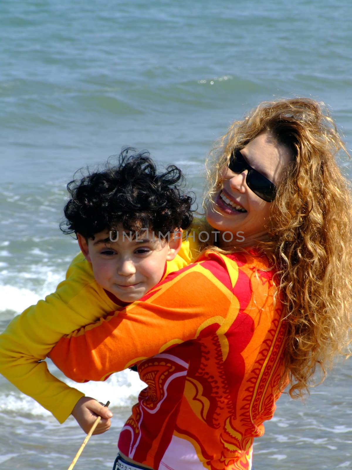 Mother and child on the beach near water