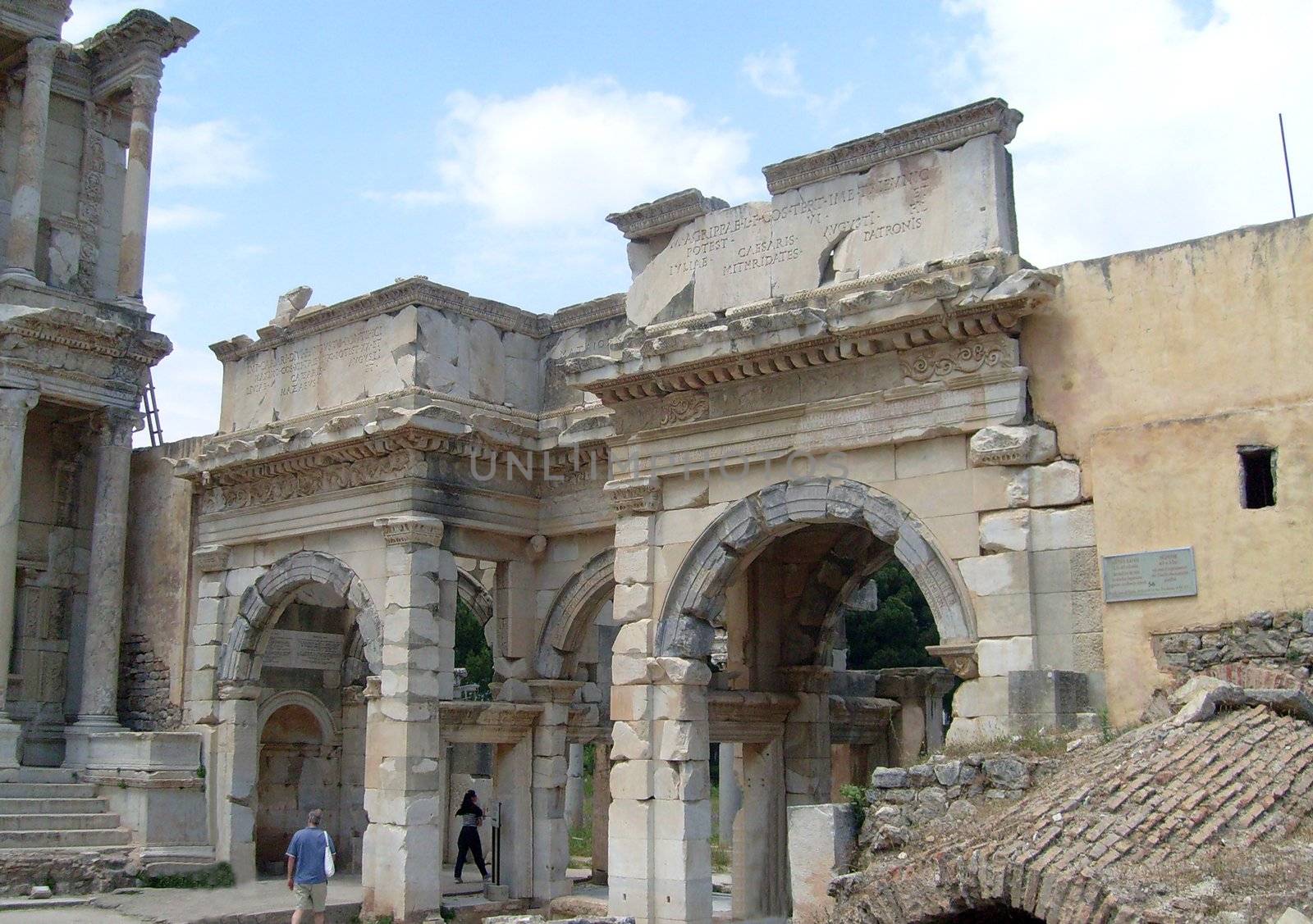 Tourists looking around Celcus Library, Ephesus, Turkey.