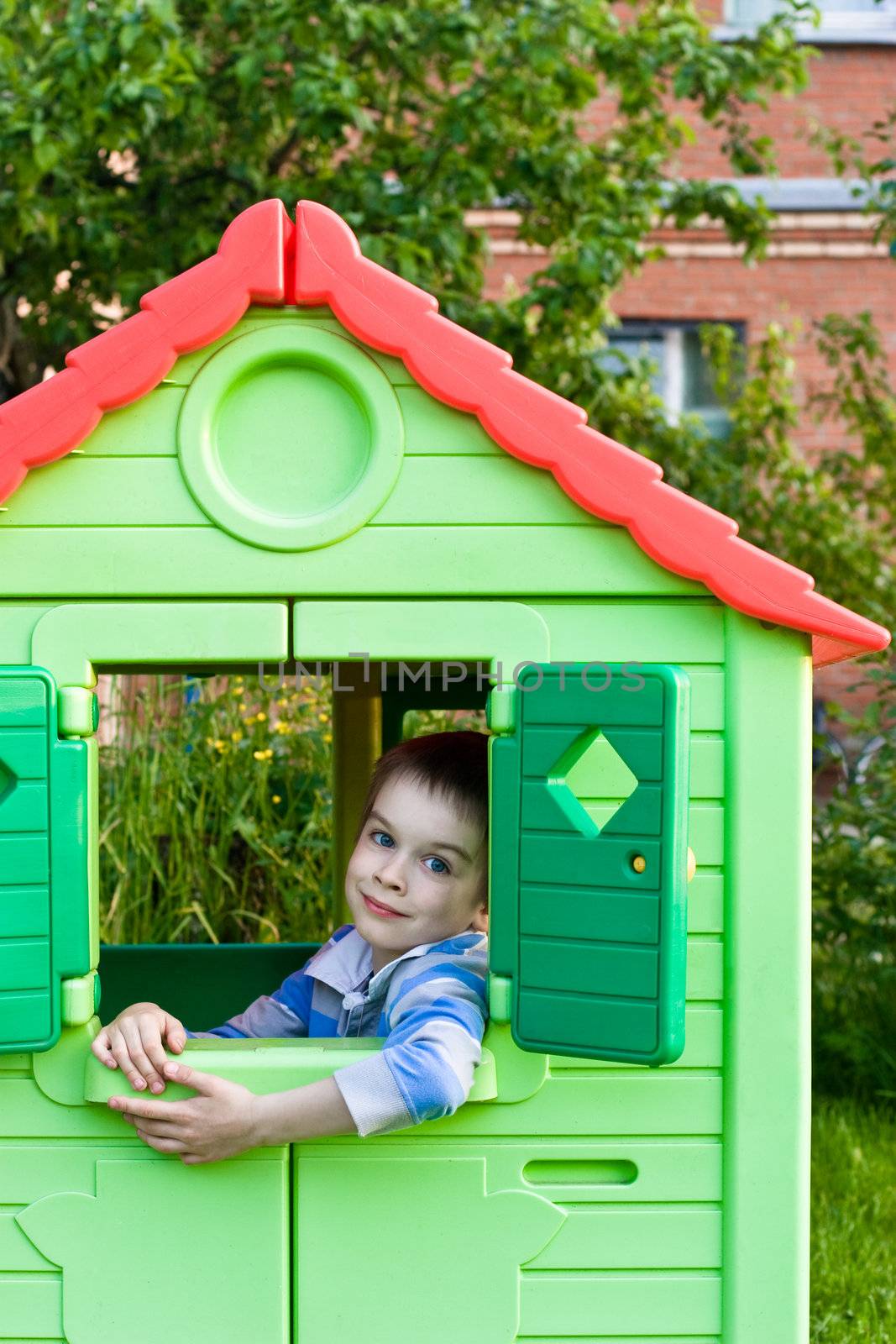 Boy in playground house by naumoid