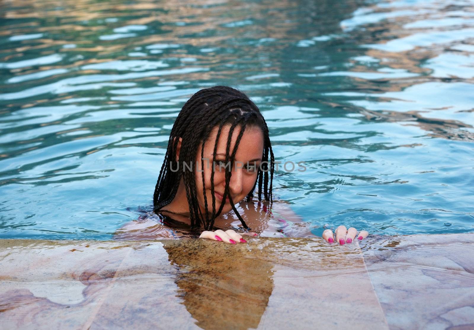 Beautiful woman enjoying summer in the pool
