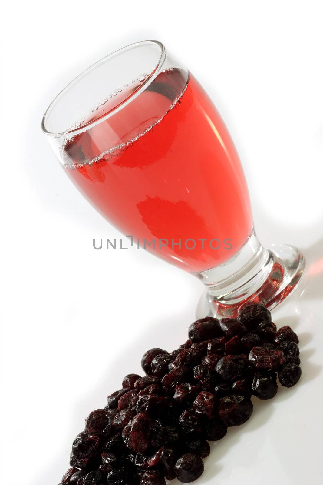 Glass of Cranberry juice on bright background