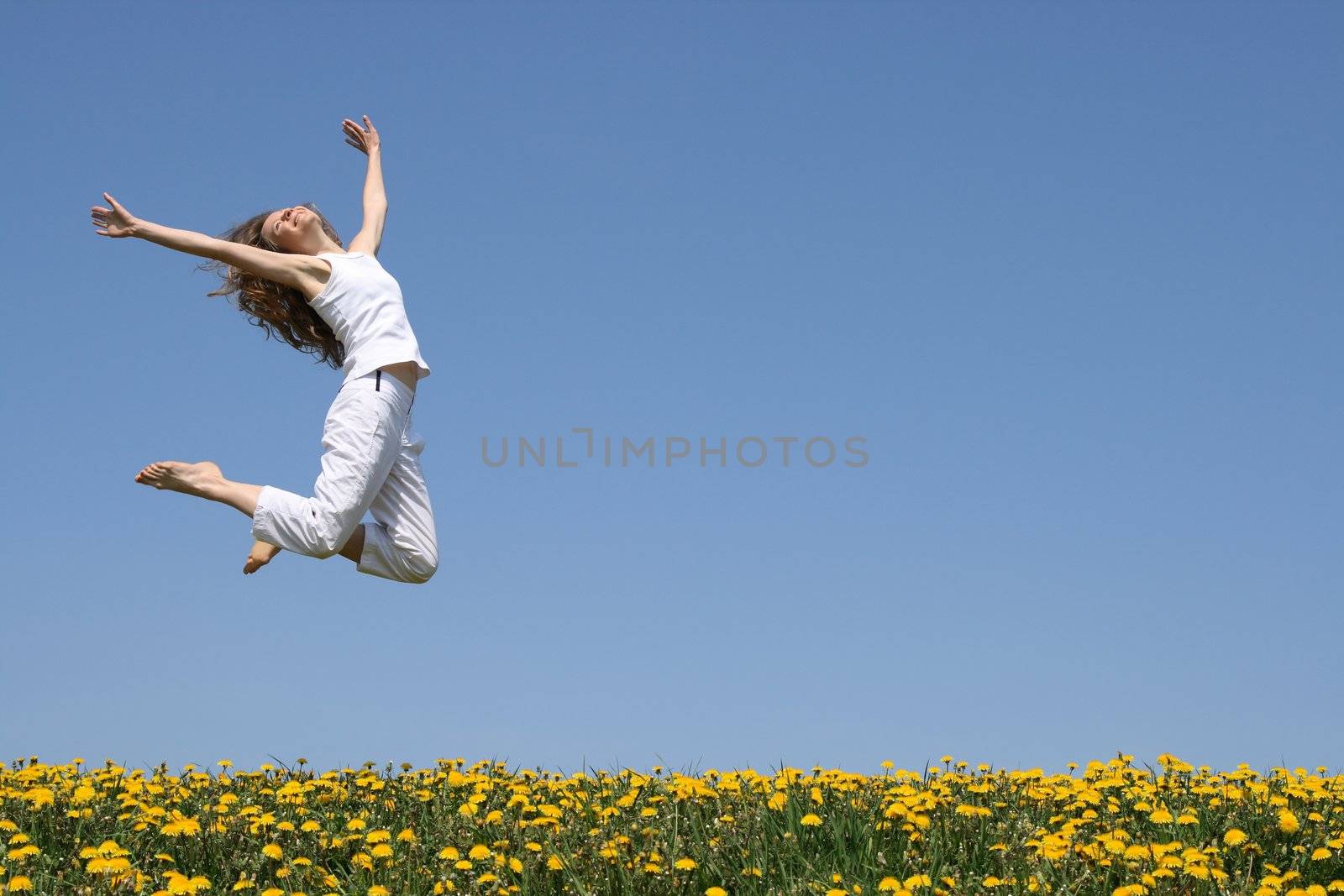 Beautiful smiling young woman in a happy jump.