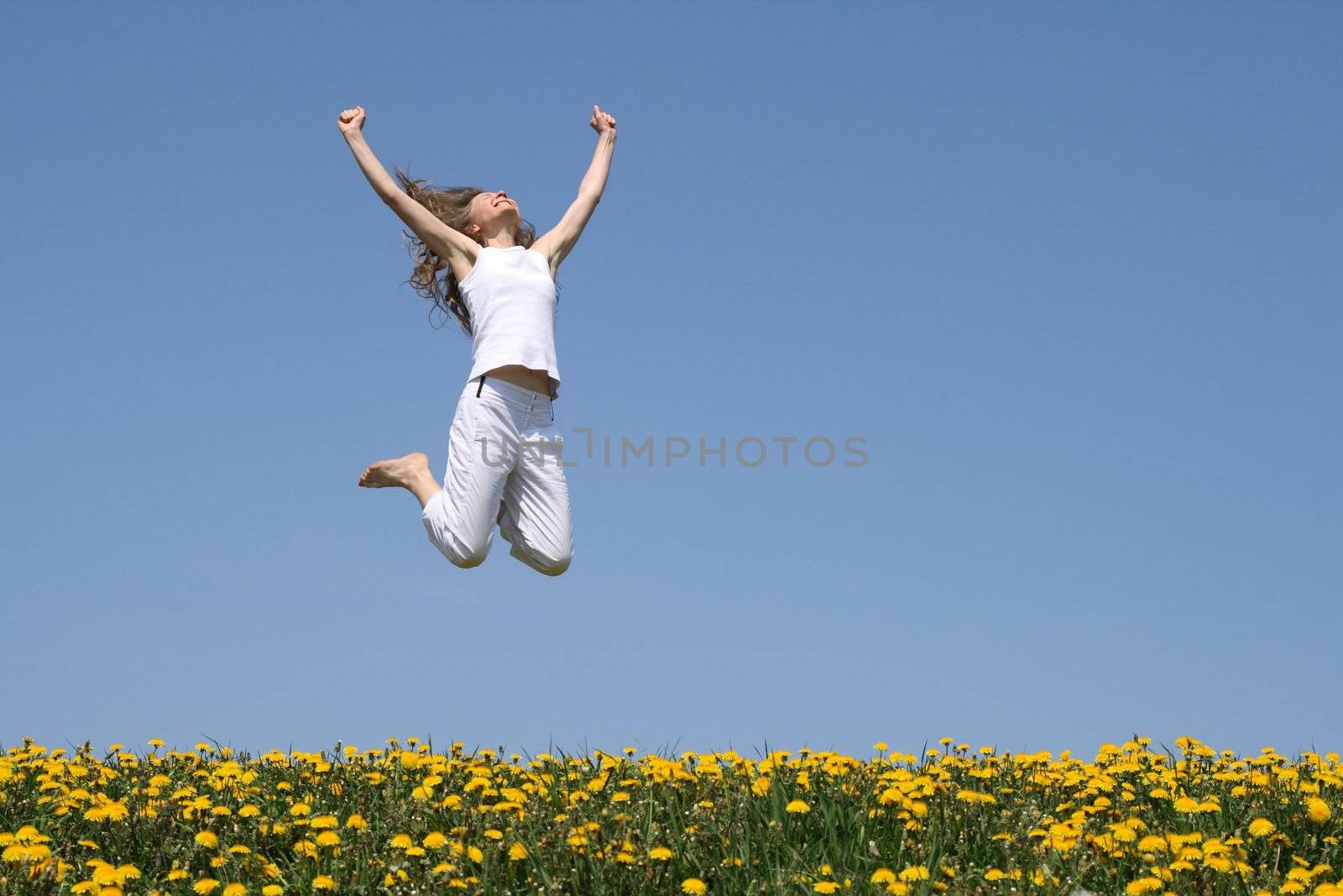 Smiling young woman in a happy jump by anikasalsera