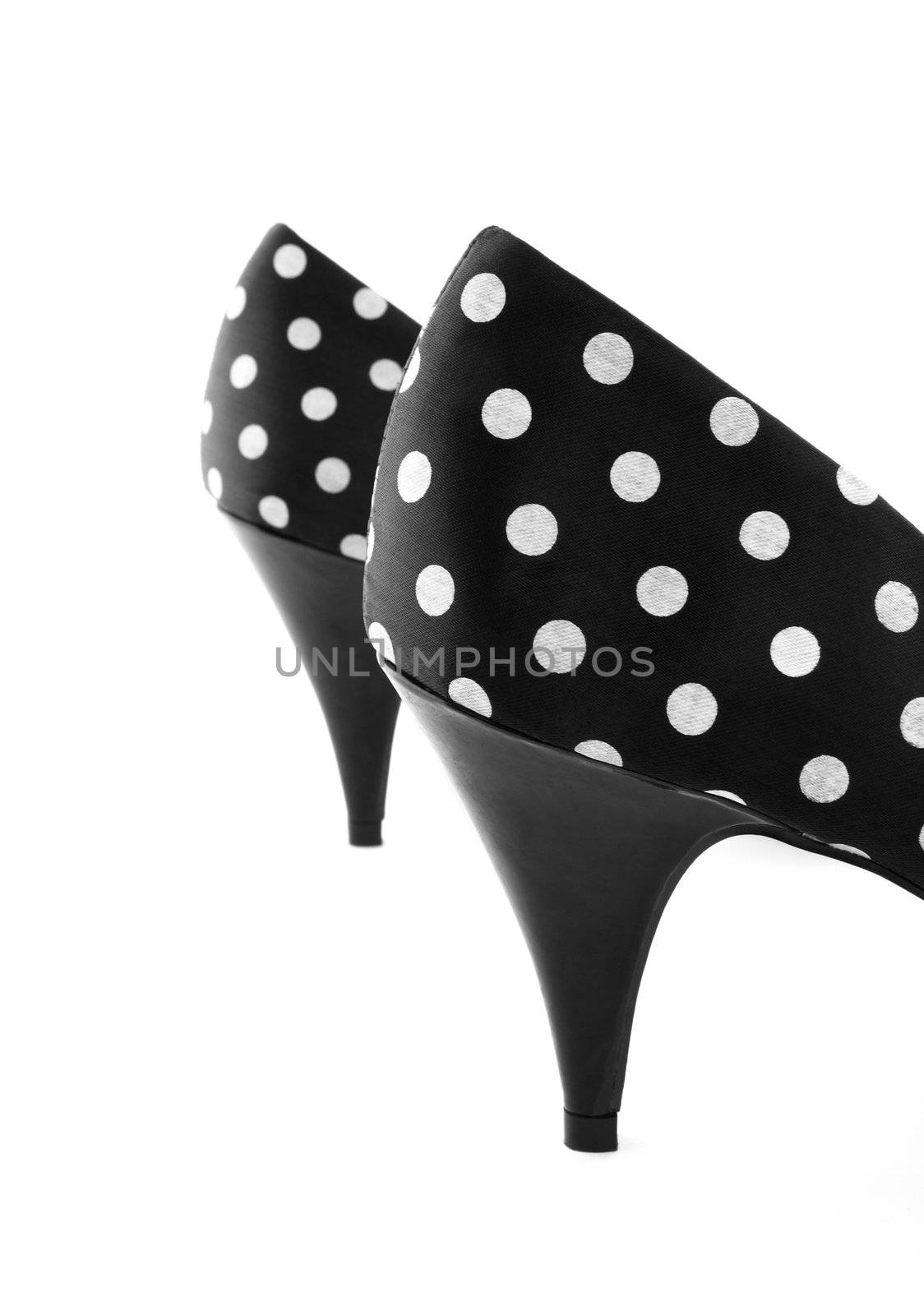 Black classic high heel polka shoes. Focus on the closest shoe.