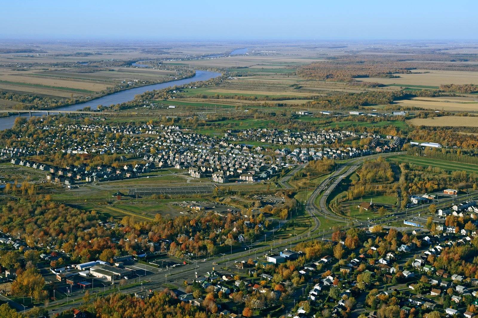 Aerial view of suburban neighborhood near highway by anikasalsera