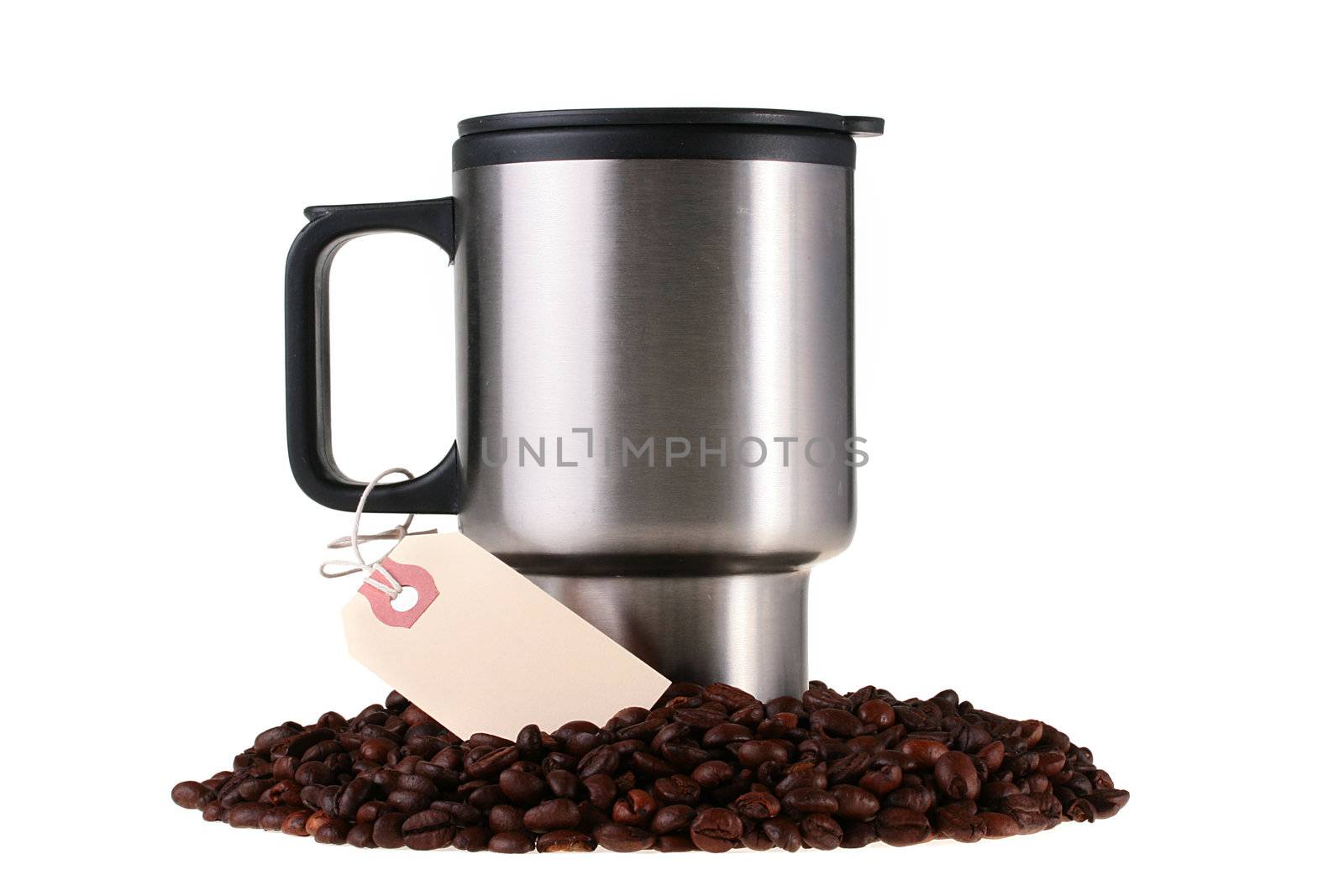 Mug for coffee among coffee grains with the label adhered to the handle.
