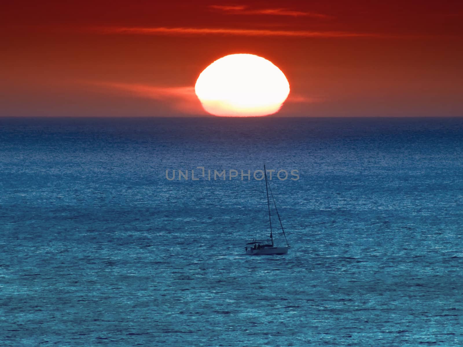 A sailing boat during a winter Mediterranean sunset