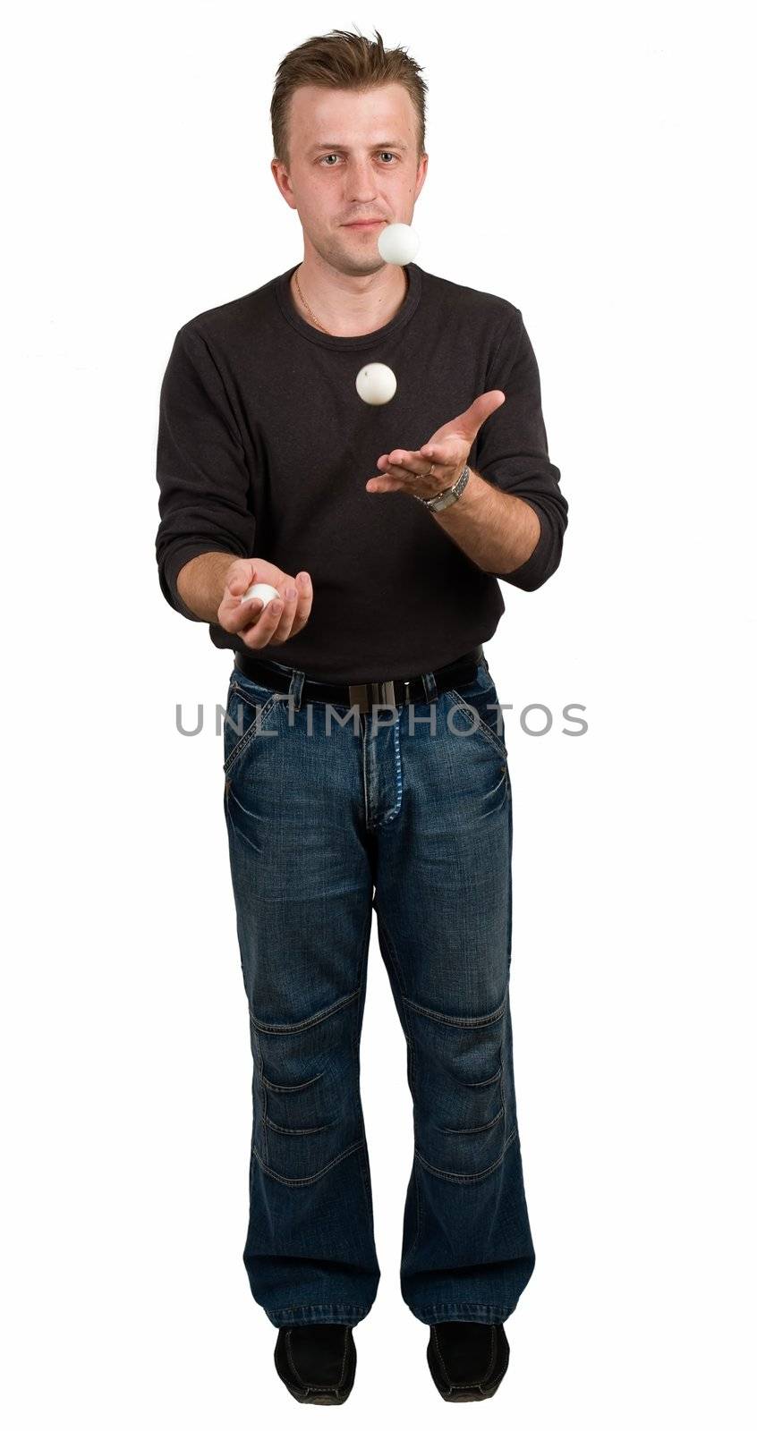 young man juggles with tennis balls on a white background