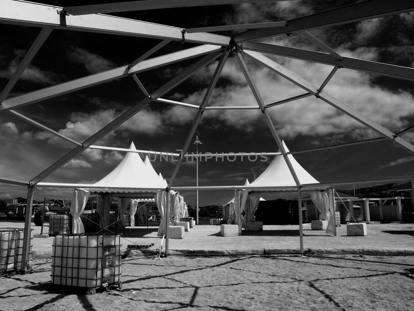 shadows playing of a structure and grids on a beach